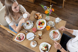 Ein junges Paar geniesst Ihr Frühstück in Hotel Konradshof in Besenfeld